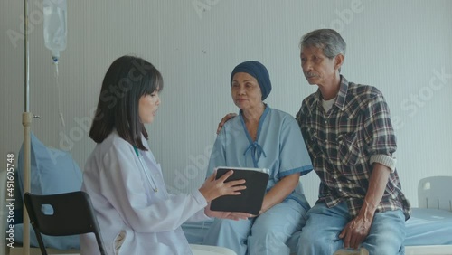 Cancer patient woman wearing head scarf after chemotherapy consulting and visiting doctor in hospital... photo