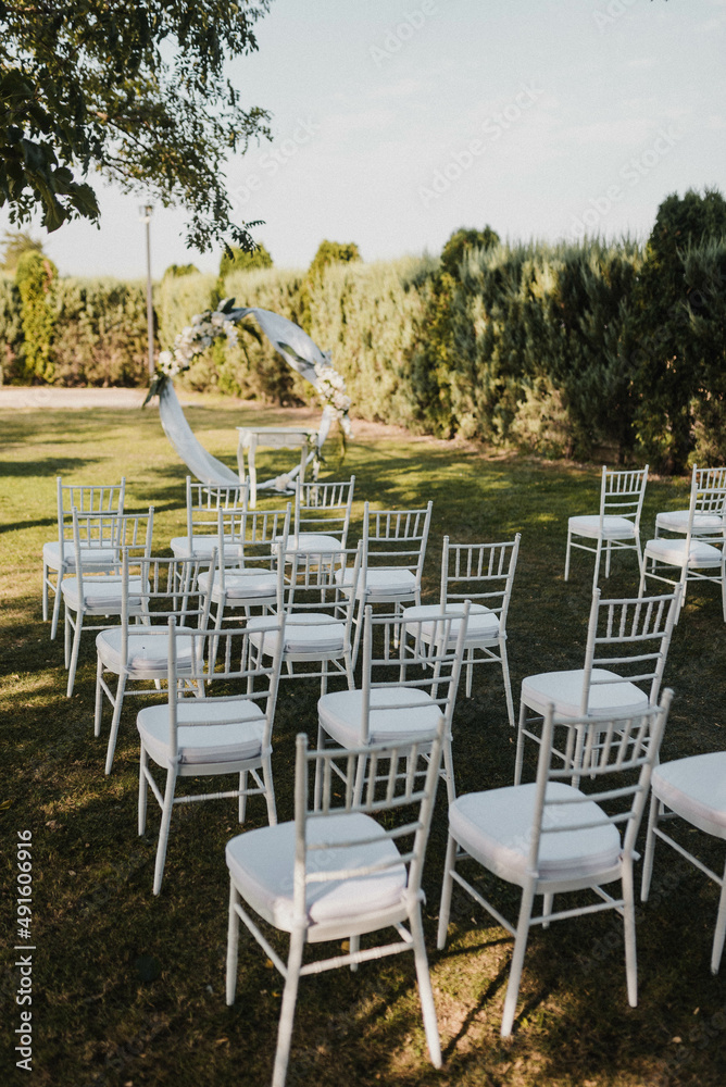 Table setting at a luxury event and beautiful flowers on the table. Beautiful wedding arch of flowers.