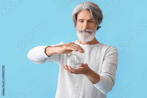 Mature man with crystal bal...
