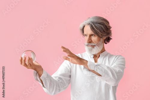 Mature man with crystal bal...
