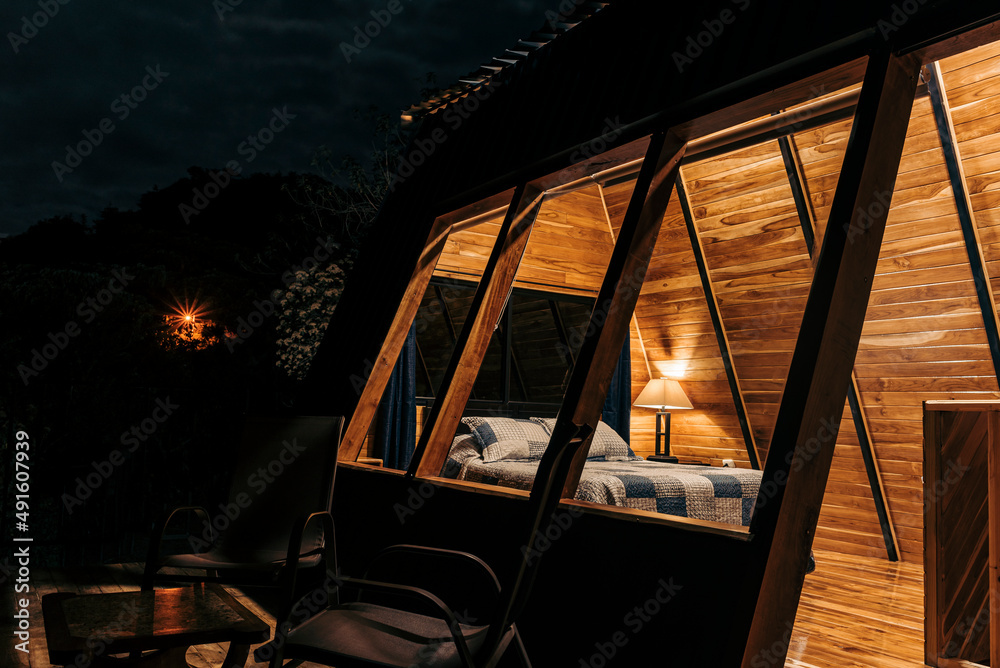 Fototapeta premium Interior of a cabin with interior lights on at night. 