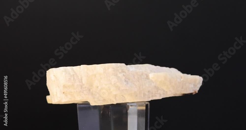 rotation of feldspar (perthite) mineral crystal on black background photo