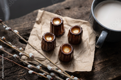 Delicious canelé cake with coffee and spring decoration