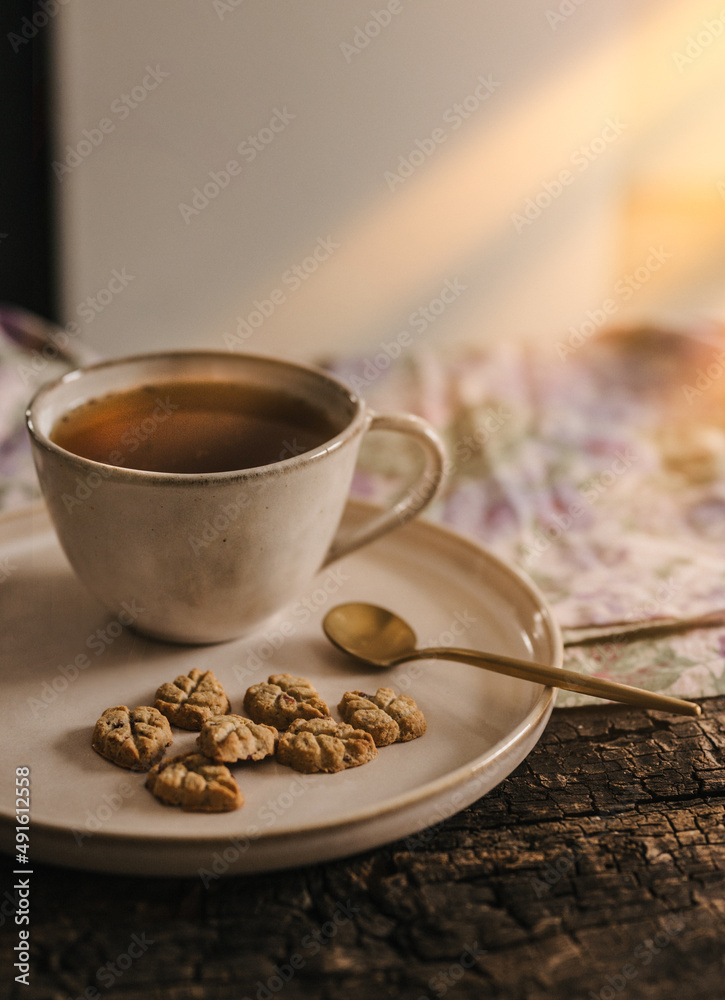 Fototapeta premium Tea with cake at the afternoon sun