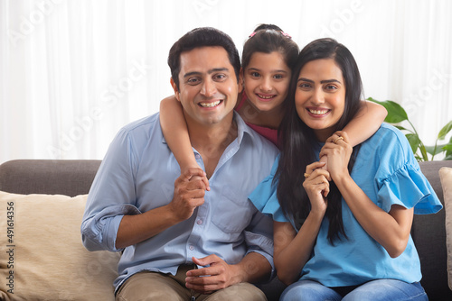 Portrait of happy couple with their little daughter