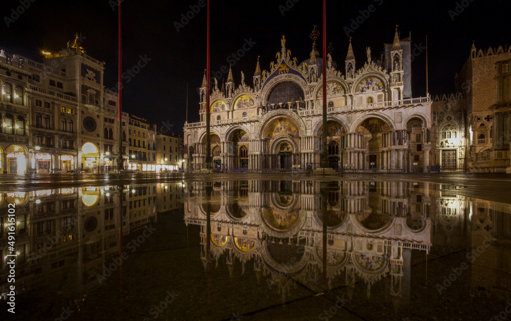 St Mark's Basilica, Venice, reflected in water, at night