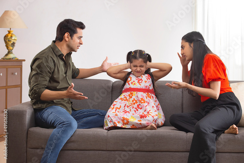 Parent  scolding their daughter for disobedience photo