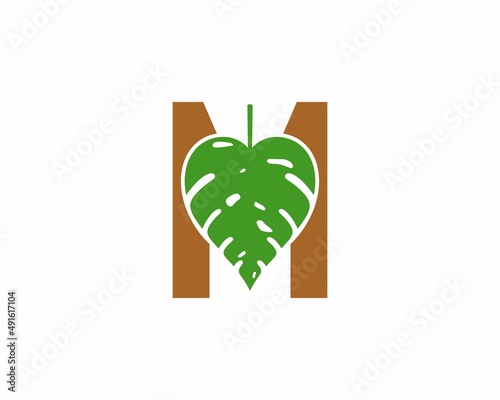M Letter with monstera leaf in the middle logo