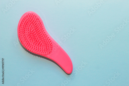 Comb plastic roses for delicate combing on a paper background.