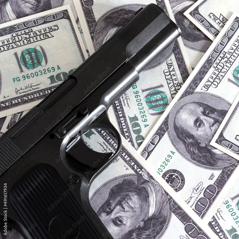 A square photo of a gun on a pile of hundred-dollar bills. Pistol tt on ...