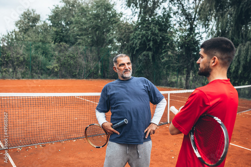 friends playing tennis outdoor on clay court