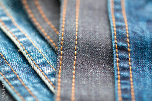 Detail of denim fabric and double stitched. weathered denim fabric.. the selected focus point