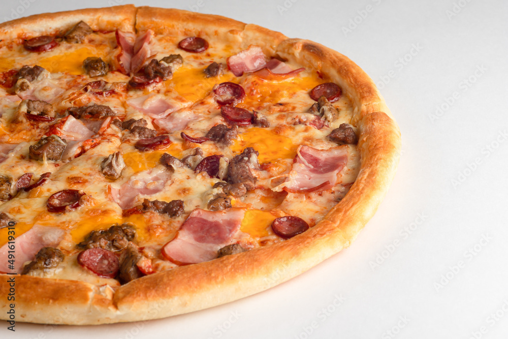Pizza with bacon, sausages, beef and cheese, on a white background