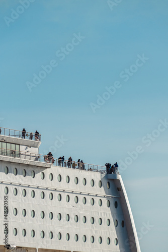 Photography Cruise ship in the port with people on the deck.