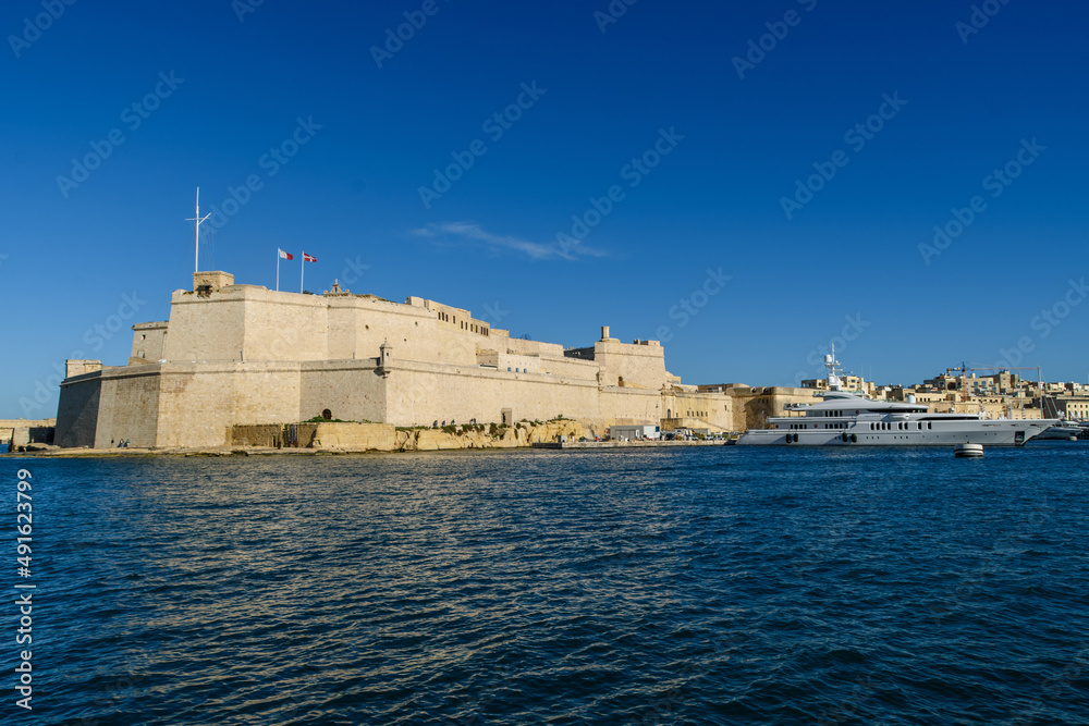 The historic city of Birgu (Vittoriosa) in Malta. At its tip poking into the Grand Harbour is the fortress Fort Saint Angelo and yachts moored in Dockyard Creek. 