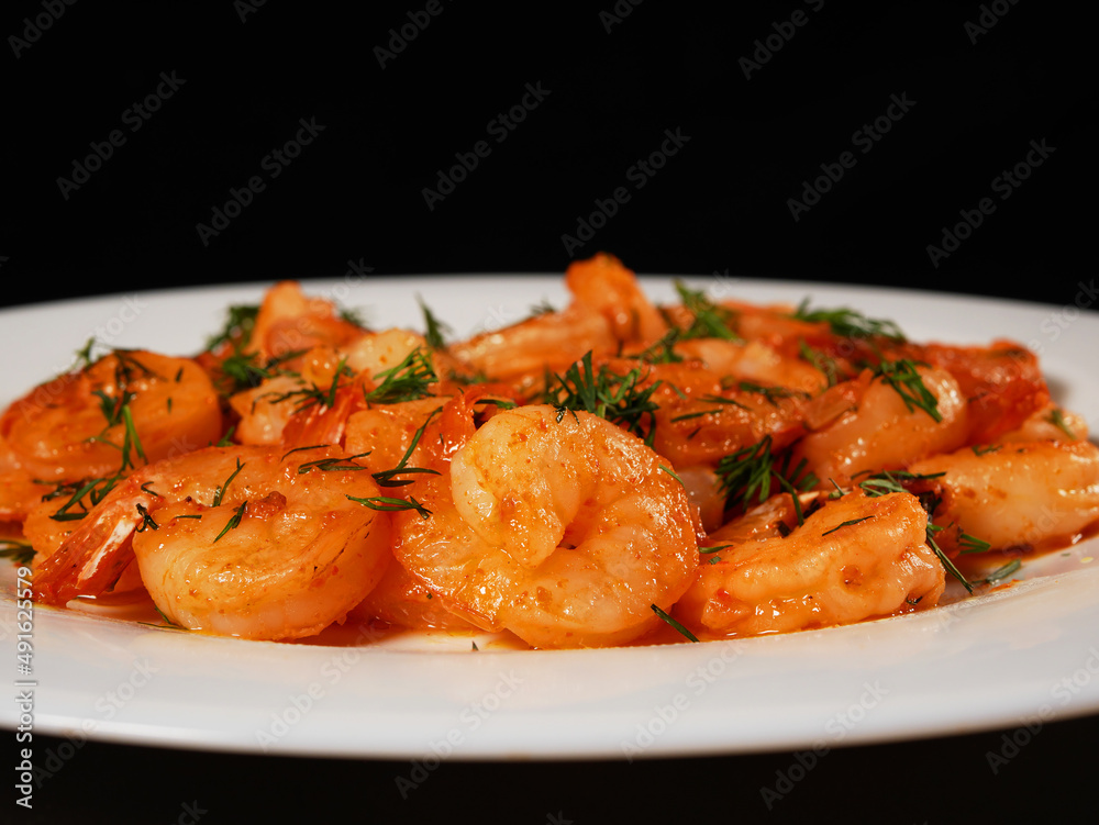 Fried king prawns on a white plate, close-up Fried king prawns on a white plate, close-up