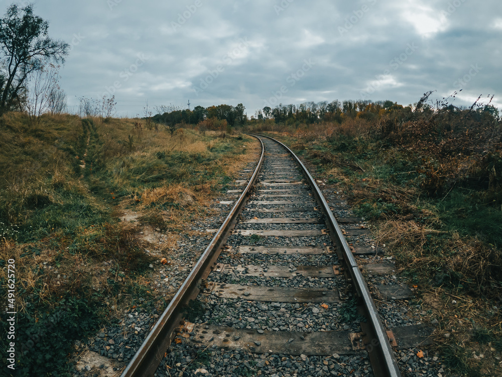 Railway track turn. Iron train rails in the countryside.