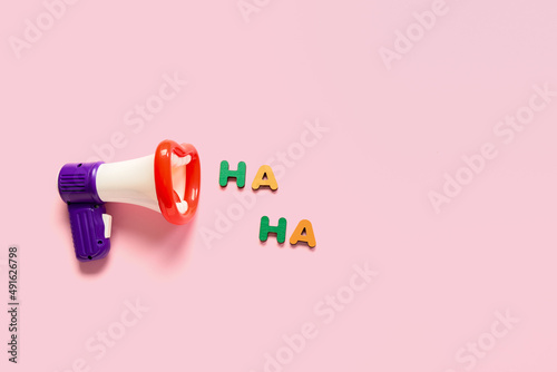 Fotomural Composition with megaphone and text HA HA for April Fools Day celebration on pin