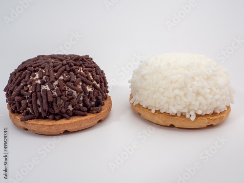 cake with coconut and chocolate chips on a white background. © Jakob