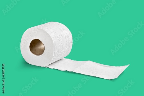 Holder with white toilet paper roll on color background
