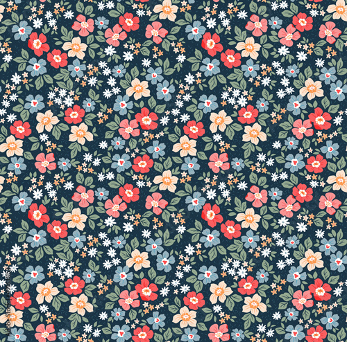 Trendy seamless vector floral pattern. Endless print made of small colorful flowers. Summer and spring motifs. Dark blue background. Stock vector illustration.