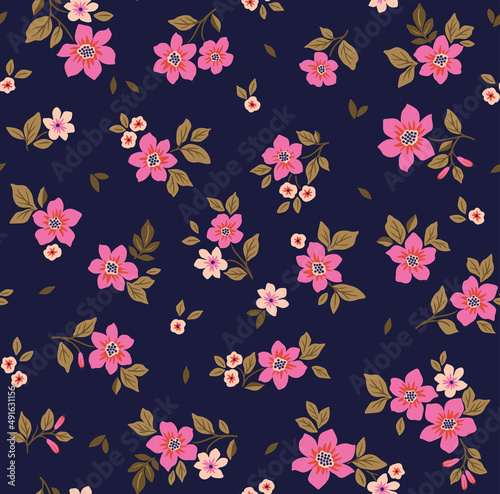 Beautiful floral pattern in small abstract flowers. Small fuchsia flowers. Dark blue background. Ditsy print. Floral seamless background. The elegant the template for fashion prints. Stock pattern.