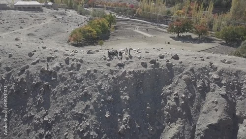 Zoom out shot by drone by a group of people standing in edge at Skardu Pakistan. photo