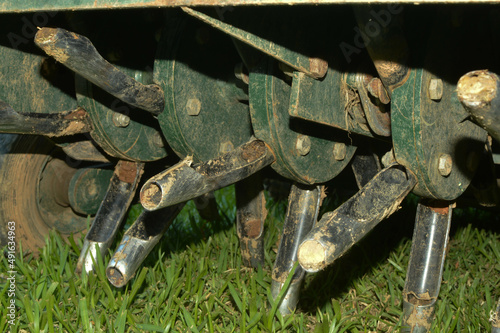 Close up of tines from lawn core aerator  photo