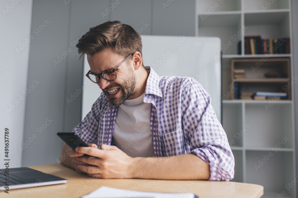 Millennial businessman working at desk in office Millennial businessman working at desk in office