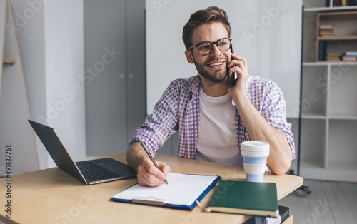 Millennial businessman working at desk in office