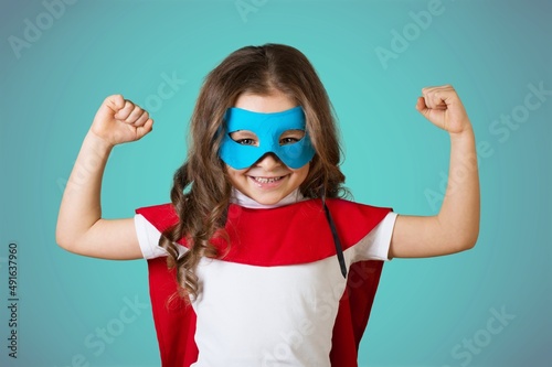 Content superhero kid in mask demonstrating power
