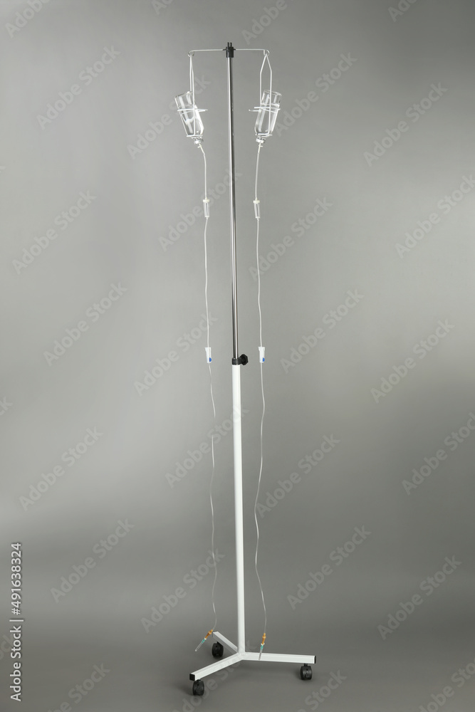 Drop counter with bottles of medicine on grey background Drop counter with bottles of medicine on grey background