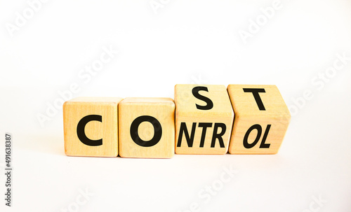 Cost control symbol. Turned wooden cubes and changed the concept word Cost to Control. Beautiful white table white background, copy space. Business cost control concept.