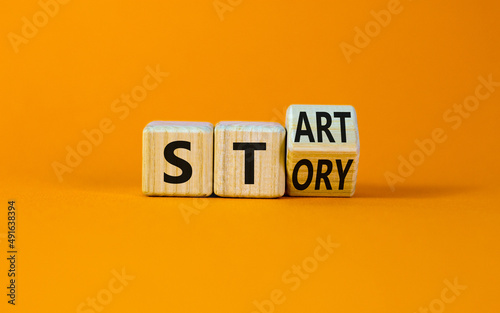 Start your story symbol. Turned the wooden cube and changed the concept word Start to Story. Beautiful orange table orange background, copy space. Business start your story concept.