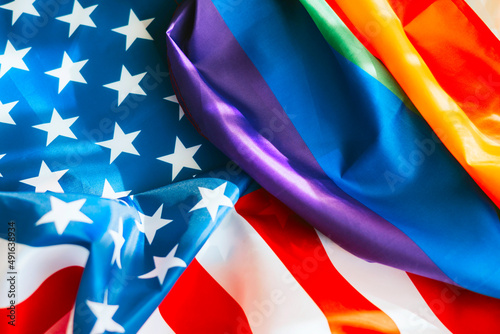 Two flags lie side by side, the flag of America USA and the flag of the LGBT communities pride, concept of tolerance for diverse people, support and protection