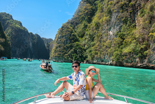Couple tourist on boat trip, happy travellers relaxing at Pileh lagoon on Phi Phi island, Krabi, Thailand. Exotic, honeymoon, love, destination Southeast Asia Travel, vacation and holiday concept © Jo Panuwat D