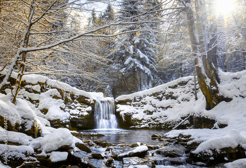 Fototapeta Naklejka Na Ścianę i Meble -  Scenic waterfall covered by snow during winter