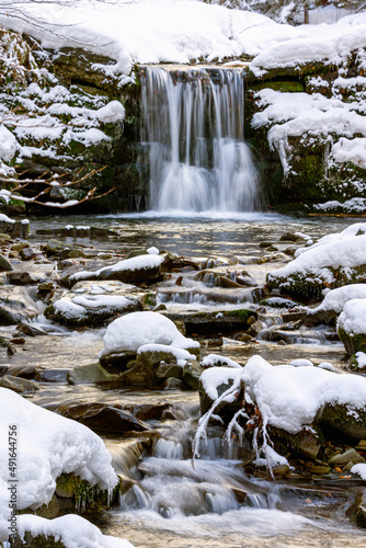 Fototapeta Naklejka Na Ścianę i Meble -  Scenic waterfall covered by snow during winter