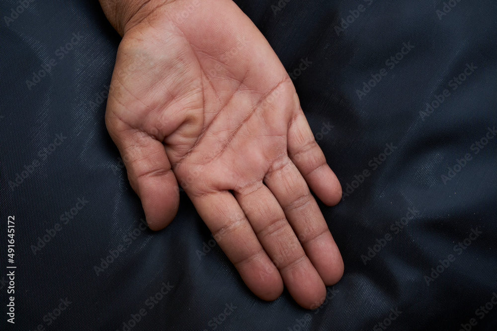 Close-up of female hand, showing thumb up. Vertical photo with asian tone and leaves on black background. Adult and vintage symbolism for greeting card. Close up of asian woman hand Close-up of female hand, showing thumb up. Vertical photo with asian tone and leaves on black background. Adult and vintage symbolism for greeting card. Close up of asian woman hand