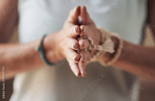 Obraz Balancing my chakras. Cropped shot of an unrecognizable woman standing with her palms together while meditating indoors.