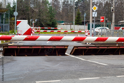 Closed railway crossing, barrier and protective barrier for road safety.