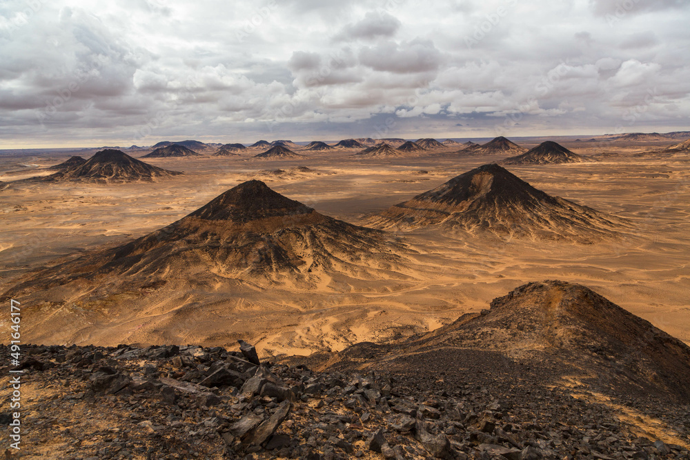 Naklejka premium Volcanic mountains in Black Desert near the Bahariya Oasis in Egypt.