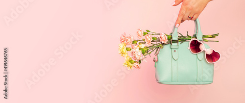 Photography Fashion spring accessories banner - mint handbag (purse) and heart shaped sunglasses on pastel pink