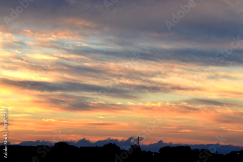 Beautiful orange sunset with clouds, nature photo background. Travel, vacation, holiday and relax theme. Gradient color. Sky texture, abstract nature background. 