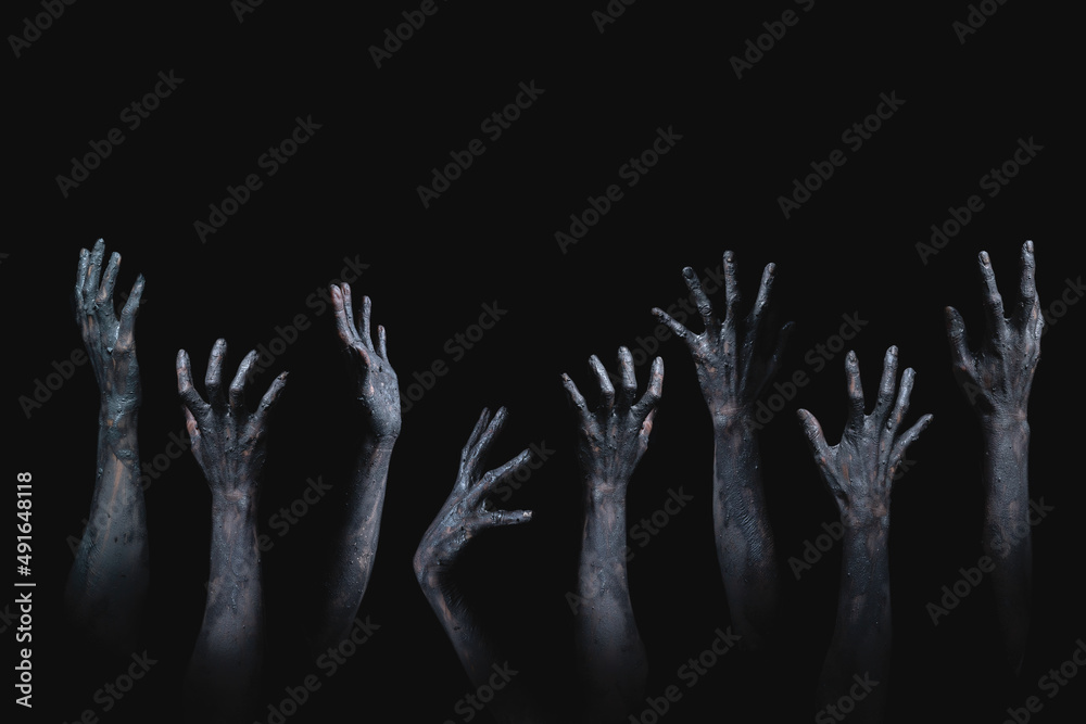 many scary and creepy zombie hands raising from darkness many scary and creepy zombie hands raising from darkness