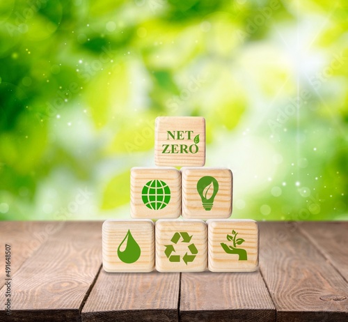 Net zero and carbon neutral concept. Put wooden cubes with green net zero icon