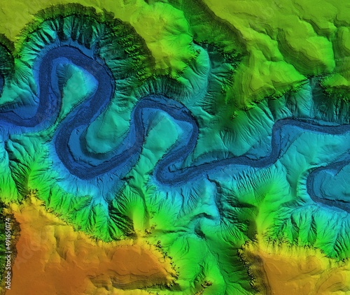Digital elevation model of a deep stone canyon. A meandering and curving river below. GIS 3D product made after proccesing aerial data.