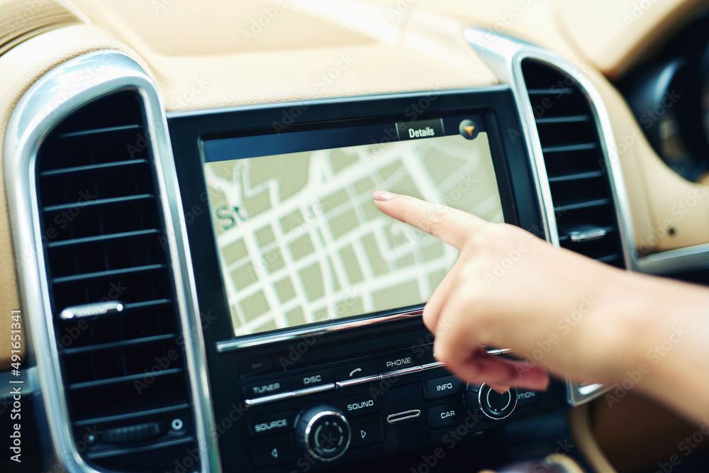 Fototapeta premium Finding locations the efficient and easy way. Shot of an unrecognizable woman using a gps in a car.