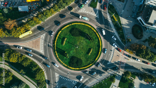 Top view of traffic and people, cars and buses at rush hour at circular junction