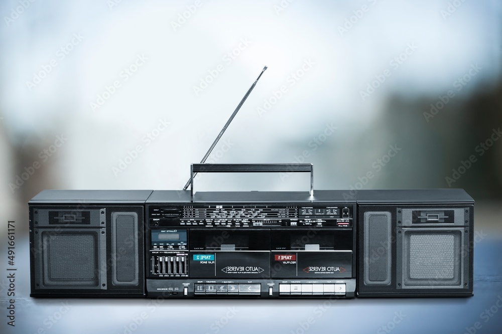 Fototapeta premium Retro boombox ghetto blaster outdated portable radio receiver with cassette recorder on the desk